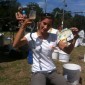 A volunteer with some recovered objects: a wine glass (unchipped), a rubber snake, and a fish plate